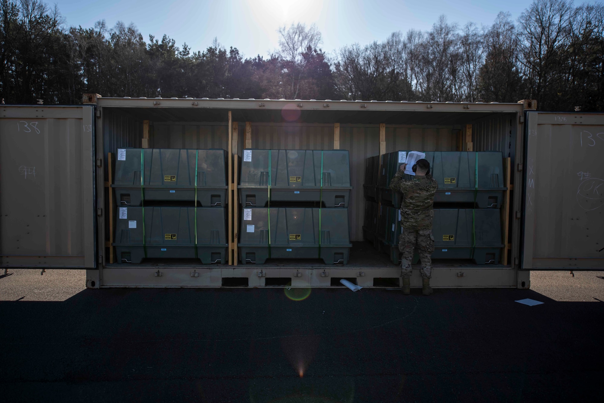 A U.S. Airman assigned to the 86th Munitions Squadron ensures the proper transport of serial numbered containers by verifying and accounting for them inside the 86th MUNS compound at Ramstein Air Base, Germany, Feb. 6, 2020. The 86th MUNS received their largest shipment of munitions in 20 years. (U.S. Air Force photo by Staff Sgt. Devin Nothstine)