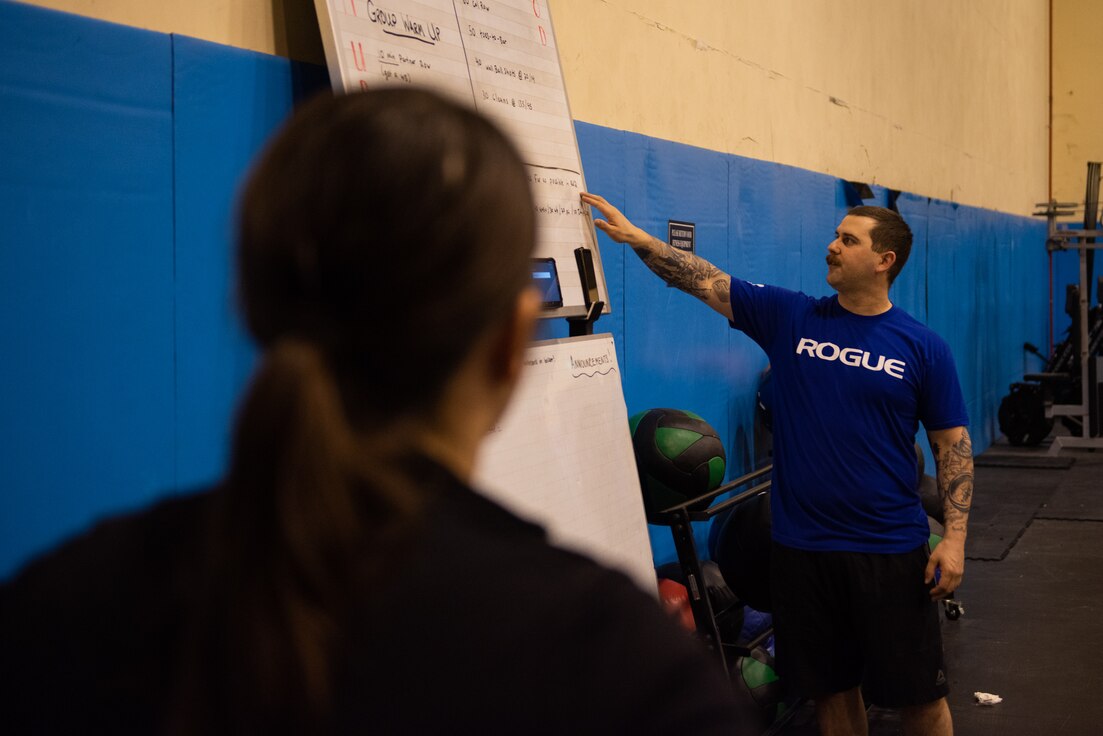 U.S. Air Force Senior Airman Eric Cooke, weapons director at the 606th Air Control Squadron and volunteer CrossFit coach, explains the workout of the day to a class at Aviano Air Base, Italy, on Feb. 26, 2020. Cooke has coached CrossFit for two years. (U.S. Air Force photo by Tech. Sgt. Tory Cusimano)