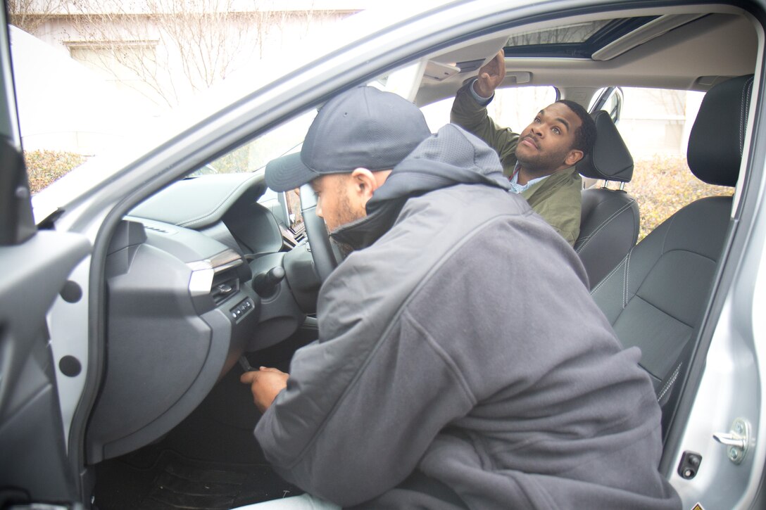 Security guards from the U.S. Army Engineer Research and Development Center examine an automobile during vehicle inspection practical exercises as part of the Department of the Army Security Guards Mobile Training Team Train-the-Trainer Course.