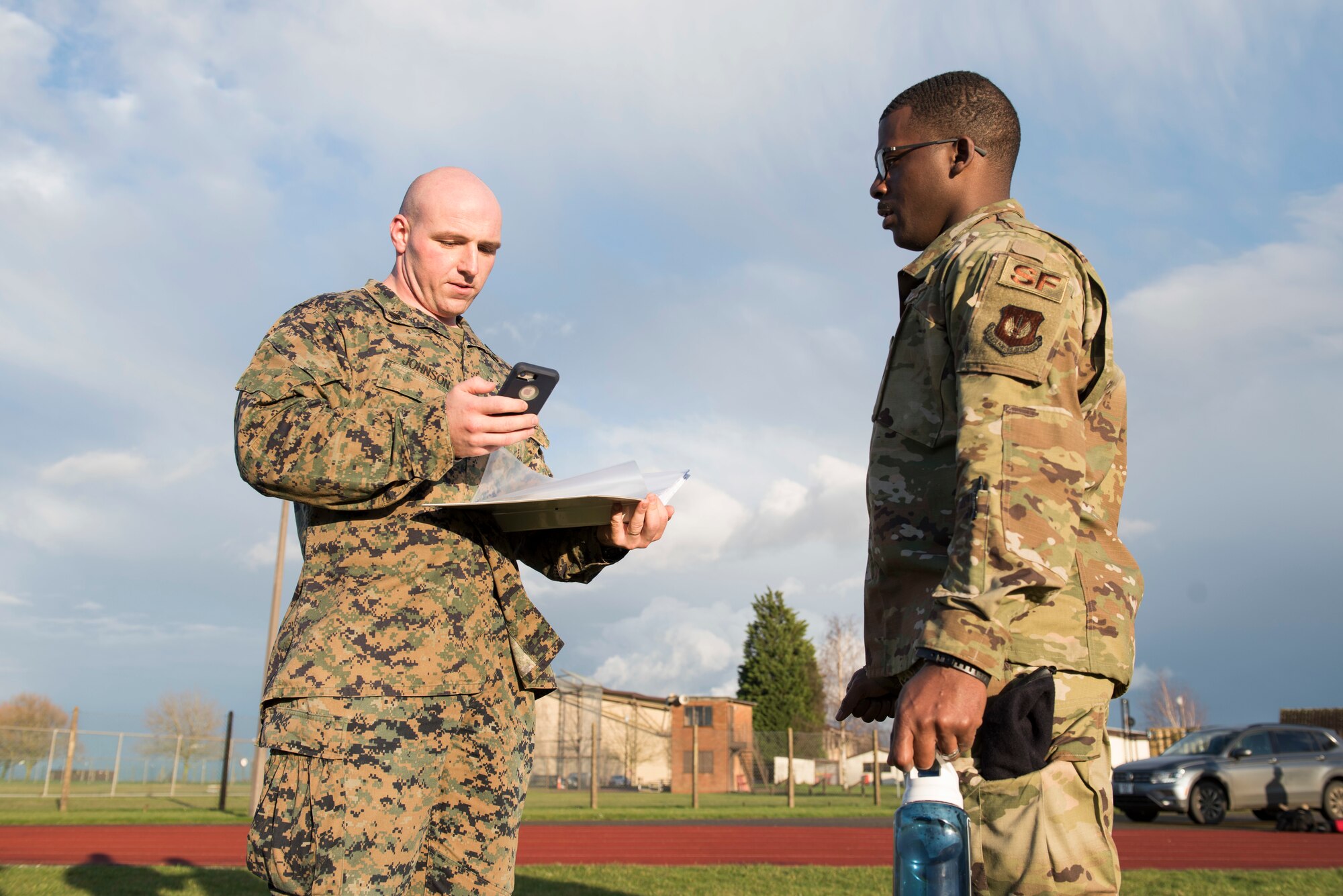 U.S. Marines Staff Sgt. Jedediah Johnson, U.S. Africa Command Directorate for Intelligence at RAF Molesworth Sahel analyst gives the score to U.S. Air Force Senior Airman David States Jr., 423rd Security Forces Squadron installation entry controller, during a practice Marine Corps Combat Fitness Test at the Joint Immersion Day at RAF Alconbury, England, Feb. 20, 2020. Joint Immersion Day was an opportunity for Air Force, Army, Marines and Navy, to come together to learn about each branch’s history, culture, structure and evaluations, in order to be aware of our similarities, differences, and needs in a joint environment. (U.S. Air Force photo by Airman 1st Class Jennifer Zima)