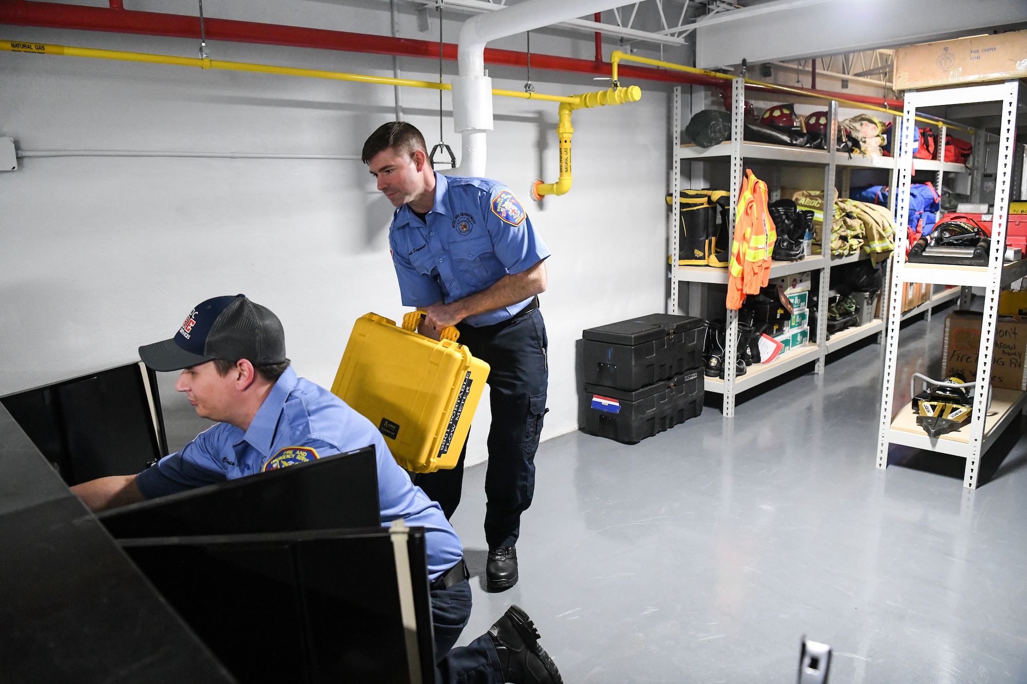 Josh Seymour, right, a firefighter with Arnold Air Force Base Fire and Emergency Services, hands a case of equipment to fellow firefighter, Chris Elsen, Jan. 21, 2020, in the FES station at Arnold AFB, Tenn.  The storage room is part of a recently completed addition to the station. (U.S. Air Force photo by Jill Pickett)