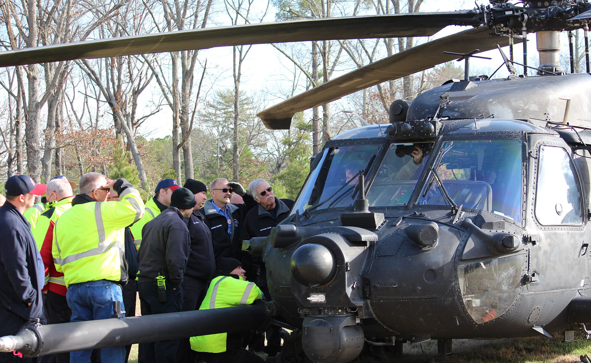 Arnold Air Force Base Fire and Emergency Services personnel listen as a member of a U.S. Army unit based at Fort Campbell, Kentucky, describes the equipment inside the helicopter as part of a training exercise Dec. 20, 2019, at Arnold Air Force Base. The training is meant to familiarize the FES personnel with the working parts of different military helicopters should they ever be called to assist in an emergency involving such aircraft. (U.S. Air Force photo by Deidre Moon)