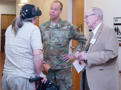 A veteran patient speaks to Chief Master Sgt. Christopher Lantagne, Joint Base San Antonio and 502nd Air Base Wing command chief, and Art Swezey, supervisor of claims representation and counseling, Texas Veterans Commission, at the Audie L. Murphy Veterans Memorial Hospital during the National Salute to Veterans Feb. 14.