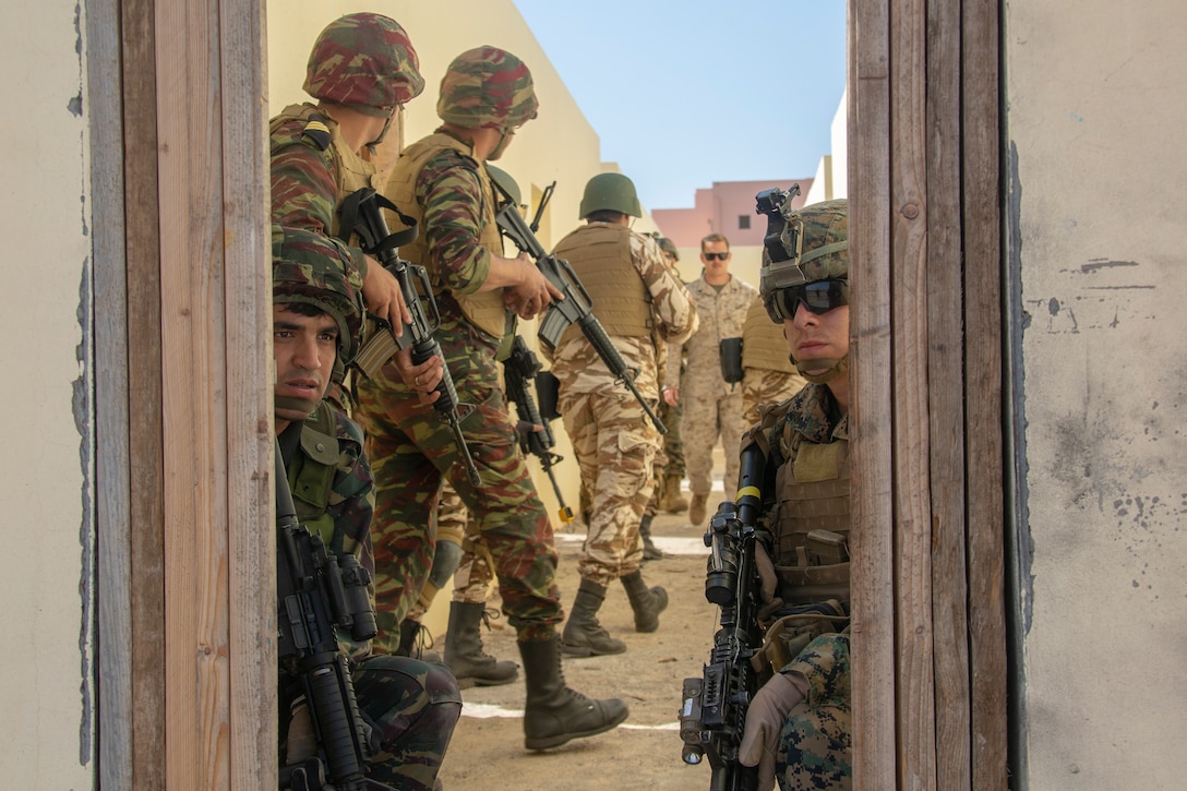 U.S. Marines secure a hostile simulated building alongside members of the Royal Moroccan Armed Forces during a quick response force, full mission profile rehearsal at Inezgane, Morocco, Feb. 26.