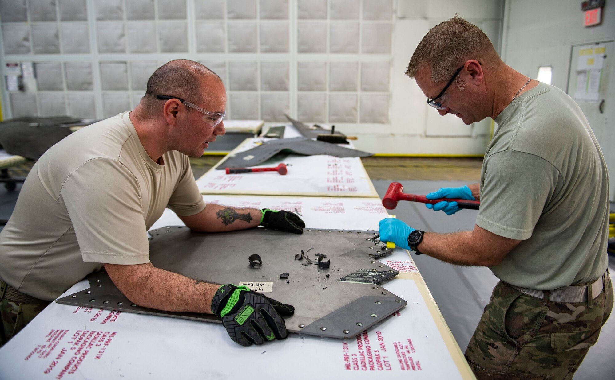 U.S. Air Force Col. Brian Laidlaw, 325th Fighter Wing commander (right), removes the coating from an F-22 Raptor panel while shadowing Airman 1st Class Orin Pickering, 325th Maintenance Squadron low observable journeyman, at Tyndall Air Force Base, Florida, Feb. 28, 2020. Laidlaw spent the morning with Pickering to learn what his job entails and even doing some of the work with him. (U.S. Air Force photo by Senior Airman Stefan Alvarez)
