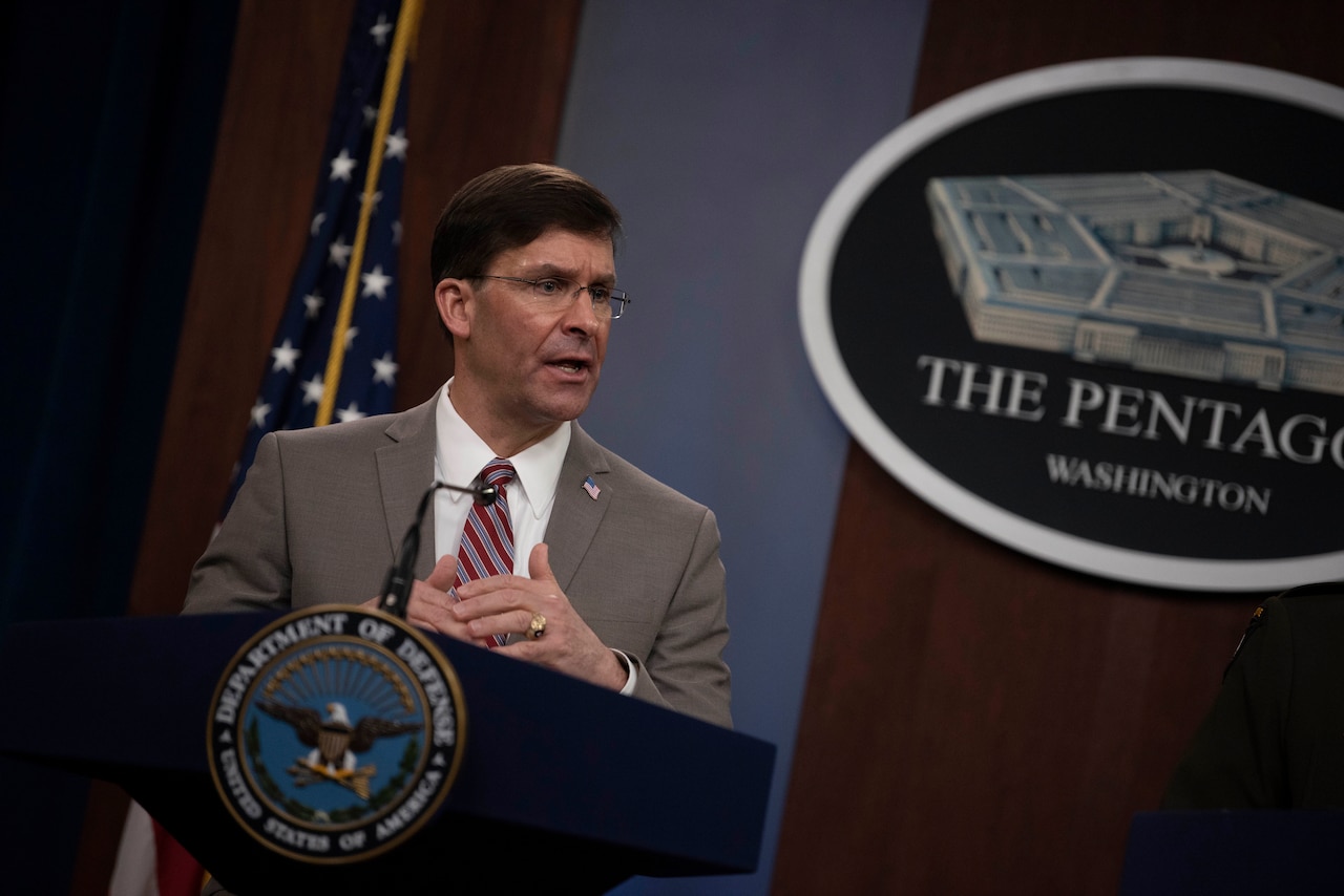 Defense Secretary Dr. Mark T. Esper speaks at a lectern.