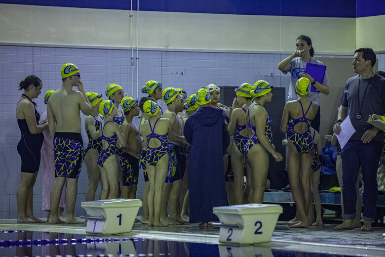 Kelly Wilkinson, head coach of the Tsunamis, speaks to her team after their warm-up at IronWorks Gym Pool, Marine Corps Air Station (MCAS) Iwakuni, Japan, February 16, 2020. The Tsunamis, the MCAS Iwakuni Schools' swim team hosted a friendly swim meet with Ocean Swim team, the local Iwakuni City swim team, in order to foster their friendship in sports. (U.S. Marine Corps photo by Lance Cpl. Triton Lai)