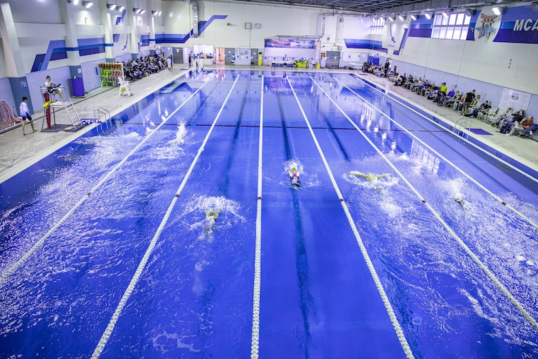 Swimmers race in a 200 meter relay at IronWorks Gym Pool, Marine Corps Air Station (MCAS) Iwakuni, Japan, February 16, 2020. The Tsunamis, the MCAS Iwakuni Schools' swim team hosted a friendly swim meet with Ocean Swim team, the local Iwakuni City swim team, in order to foster their friendship in sports. (U.S. Marine Corps photo by Lance Cpl. Triton Lai)