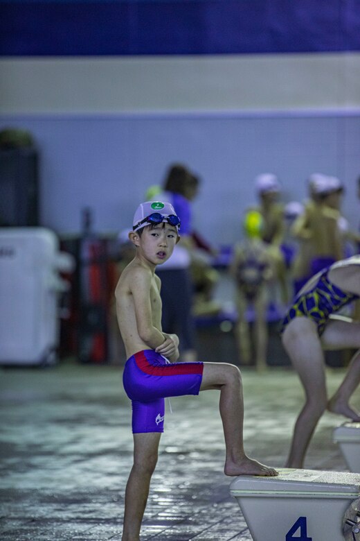 A swimmer with Ocean Swim gets ready to start a relay at IronWorks Gym Pool, Marine Corps Air Station (MCAS) Iwakuni, Japan, February 16, 2020. The Tsunamis, the MCAS Iwakuni Schools' swim team hosted a friendly swim meet with Ocean Swim team, the local Iwakuni City swim team, in order to foster their friendship in sports. (U.S. Marine Corps photo by Lance Cpl. Triton Lai)