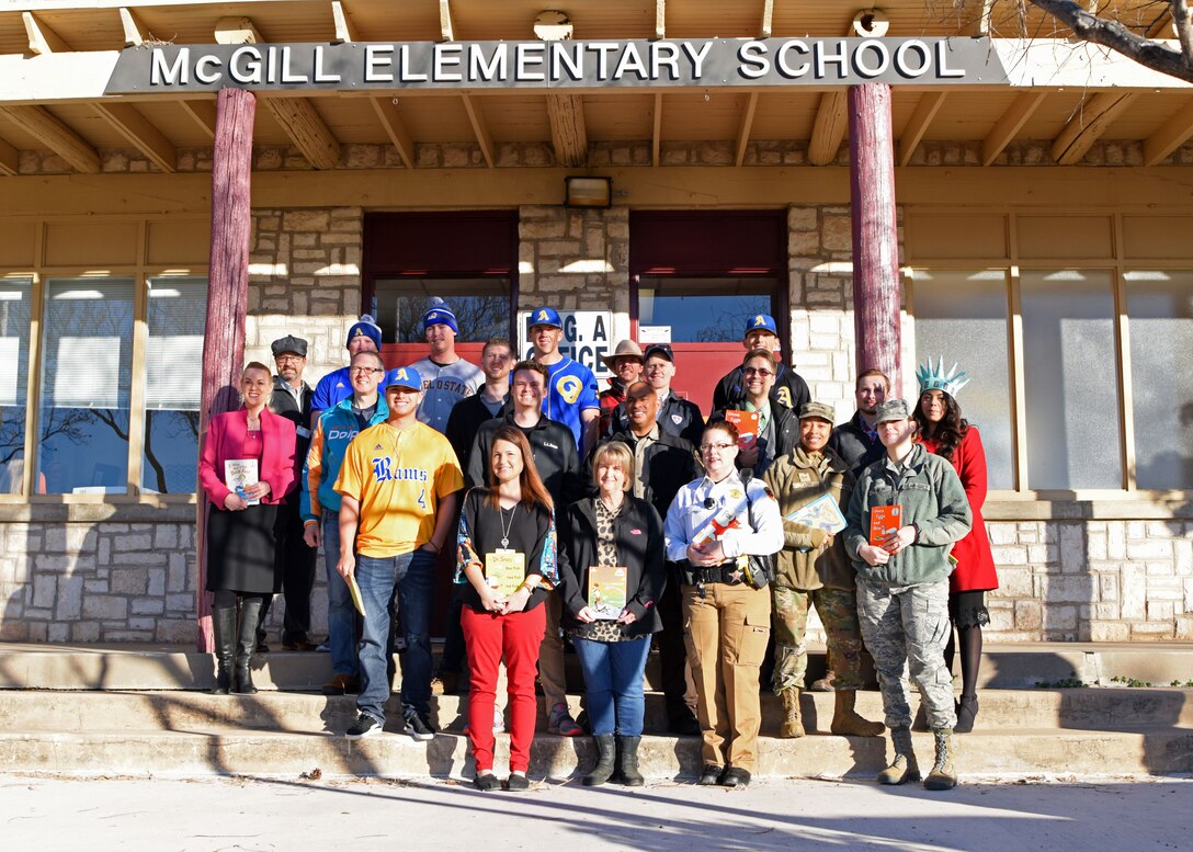 Members of the Goodfellow community present their books before reading to their various classrooms at McGill Elementary School in San Angelo, Texas, Feb. 27, 2020. The annual event is one looked forward to by the community, the kids, and the teachers. (U.S. Air Force photo by Airman 1st Class Ethan Sherwood)