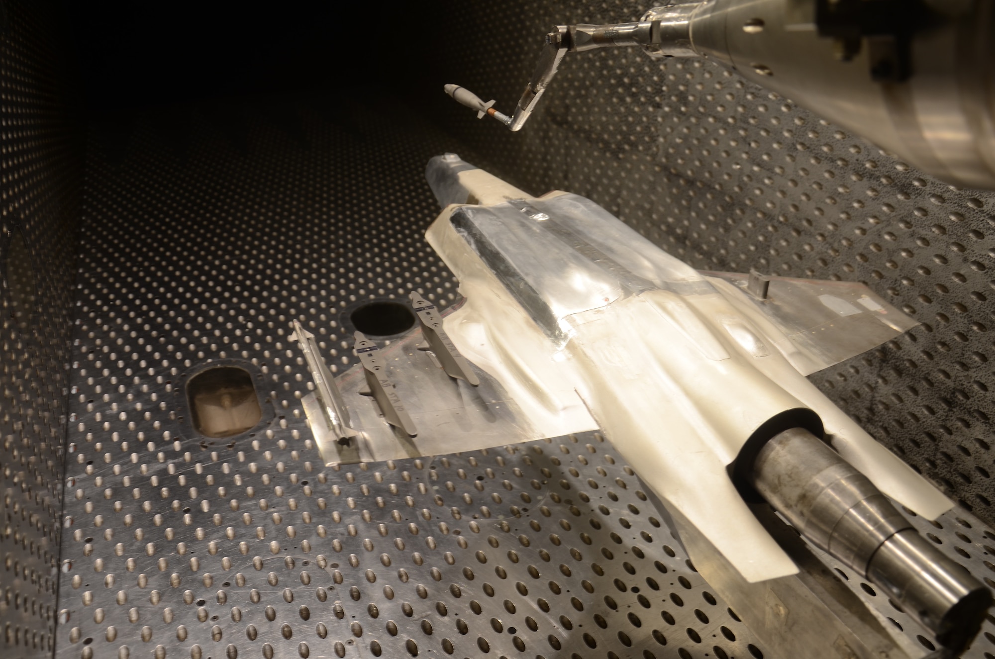 A 1/15th scale model of an F-35 Lightning II Joint Strike Fighter undergoes store separation testing in the Arnold Engineering Development Complex 4-foot transonic wind tunnel, known as 4T, at Arnold Air Force Base. (U.S. Air Force photo)