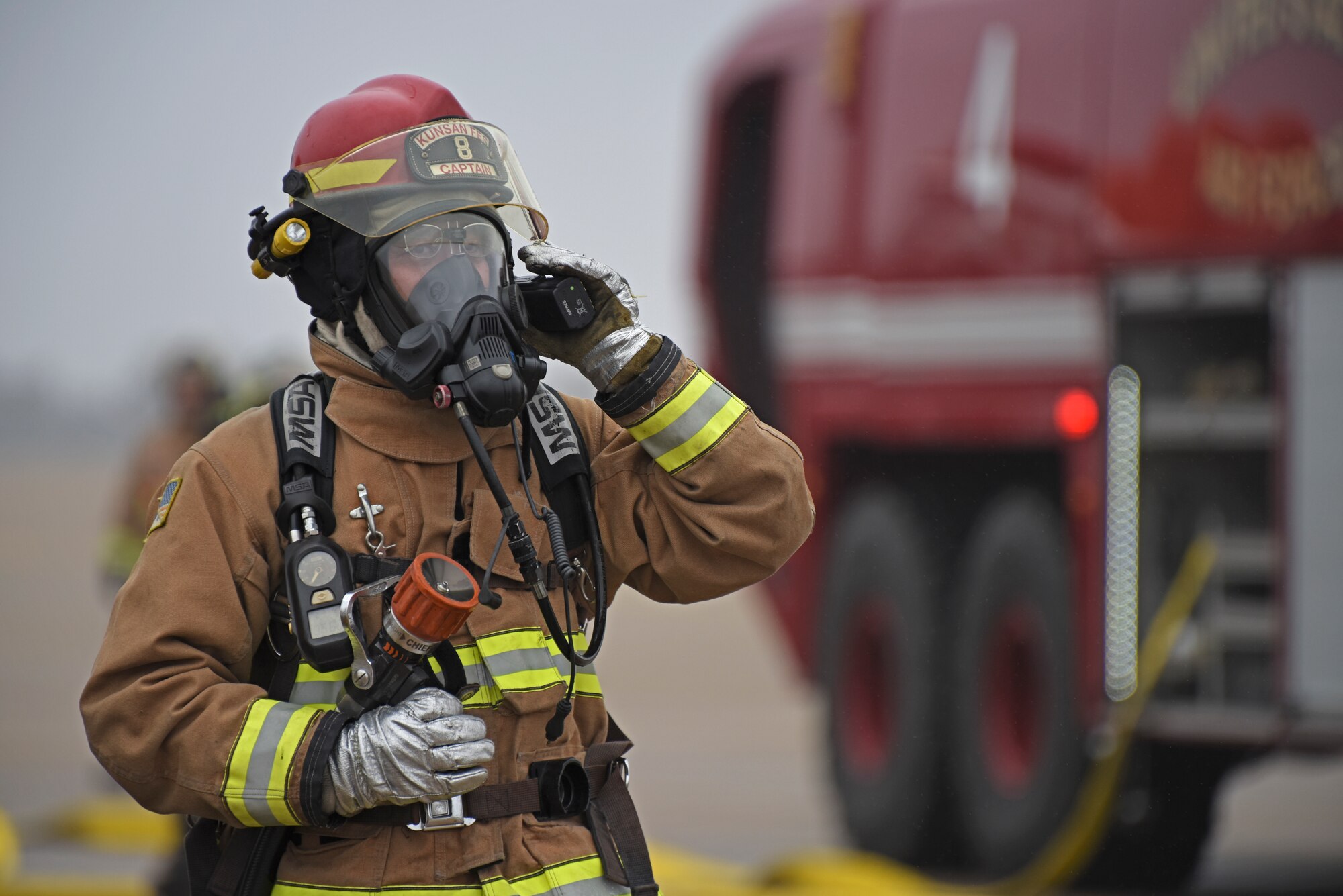 A U.S. Air Force firefighter assigned to the 8th Civil Engineer Squadron prepares to conduct live fire training at Kunsan Air Base, Republic of Korea, Feb. 13, 2020. Live aircraft fire training ensures 8th CES firefighters are proficient in the steps needed to properly fight aircraft fires. (U.S. Air Force photo by Staff Sgt. Anthony Hetlage)