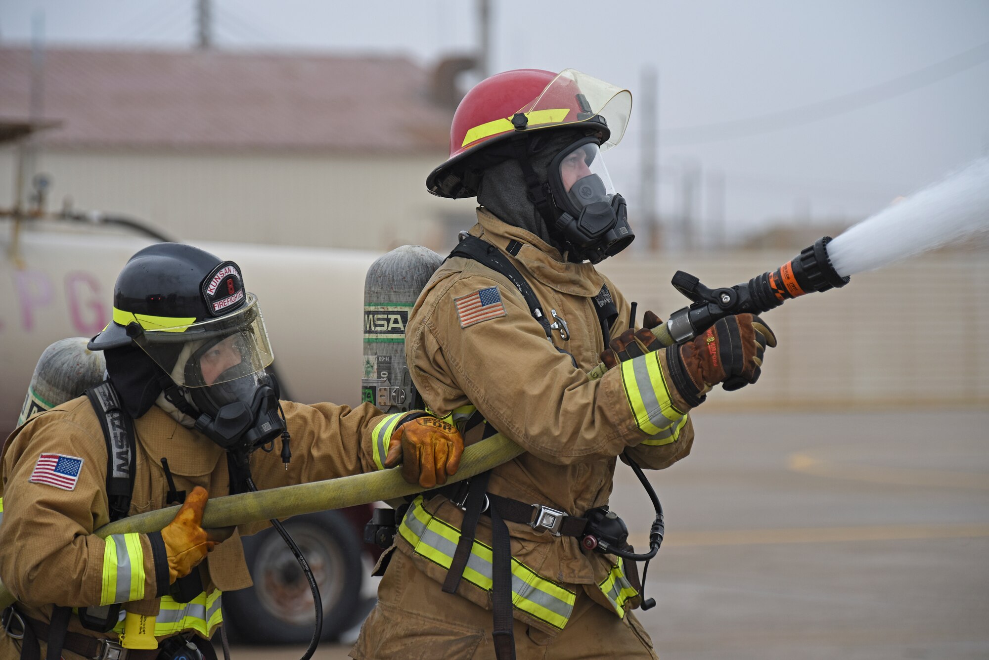 A U.S. Air Force firefighter assigned to the 8th Civil Engineer Squadron prepares to conduct live fire training at Kunsan Air Base, Republic of Korea, Feb. 13, 2020. Live aircraft fire training ensures 8th CES firefighters are proficient in the steps needed to properly fight aircraft fires. (U.S. Air Force photo by Staff Sgt. Anthony Hetlage)