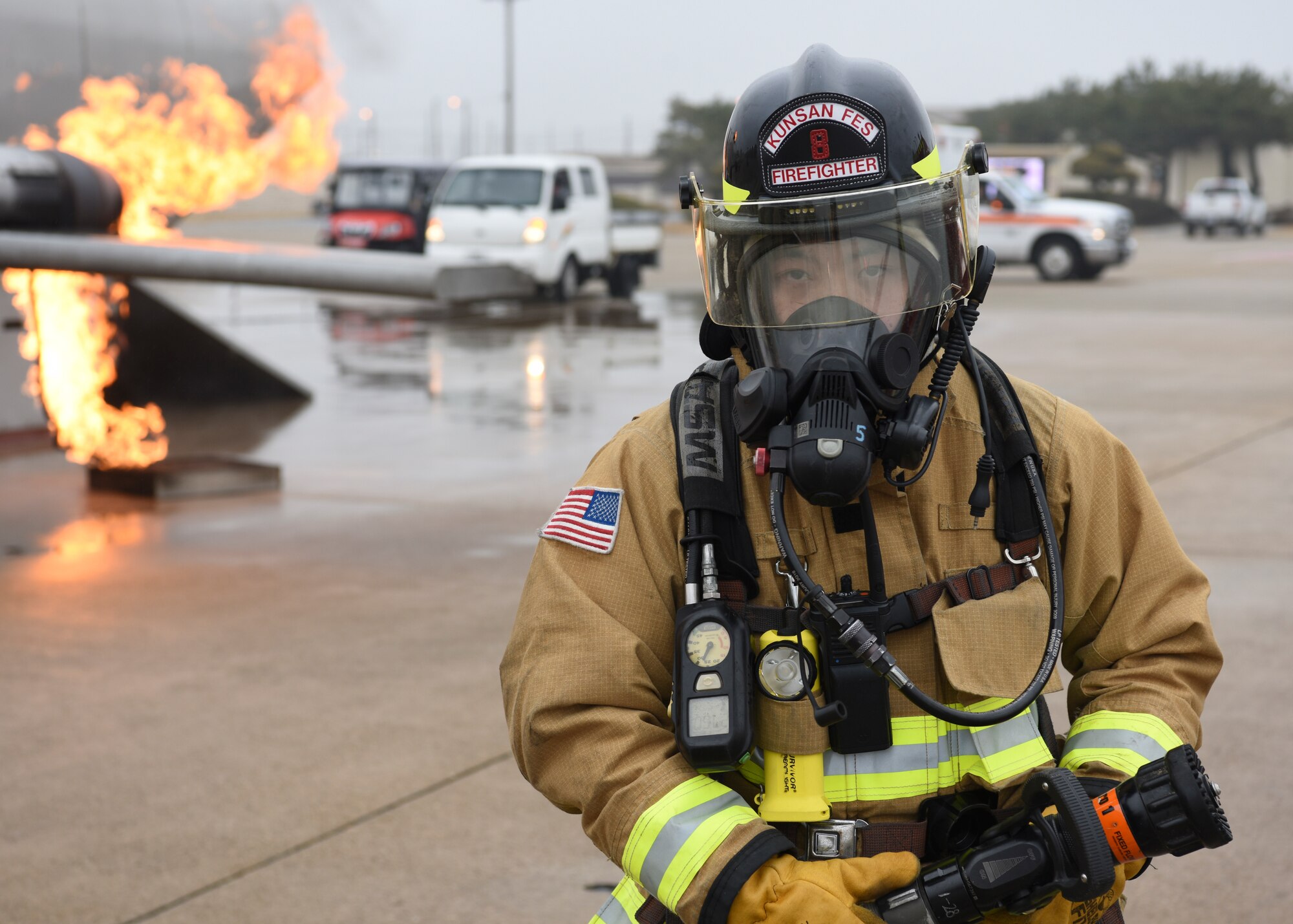 A U.S. Air Force firefighter assigned to the 8th Civil Engineer Squadron prepares to conduct live fire training at Kunsan Air Base, Republic of Korea, Feb. 13, 2020. Live aircraft fire training ensures 8th CES firefighters are proficient in the steps needed to properly fight aircraft fires. (U.S. Air Force photo by Staff Sgt. Anthony Hetlage)