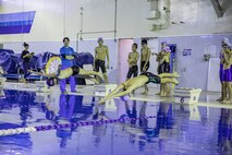 Swimmers dive into the water during a relay at IronWorks Gym Pool, Marine Corps Air Station (MCAS) Iwakuni, Japan, February 16, 2020. The Tsunamis, the MCAS Iwakuni Schools' swim team hosted a friendly swim meet with Ocean Swim team, the local Iwakuni City swim team, in order to foster their friendship in sports. (U.S. Marine Corps photo by Lance Cpl. Triton Lai)