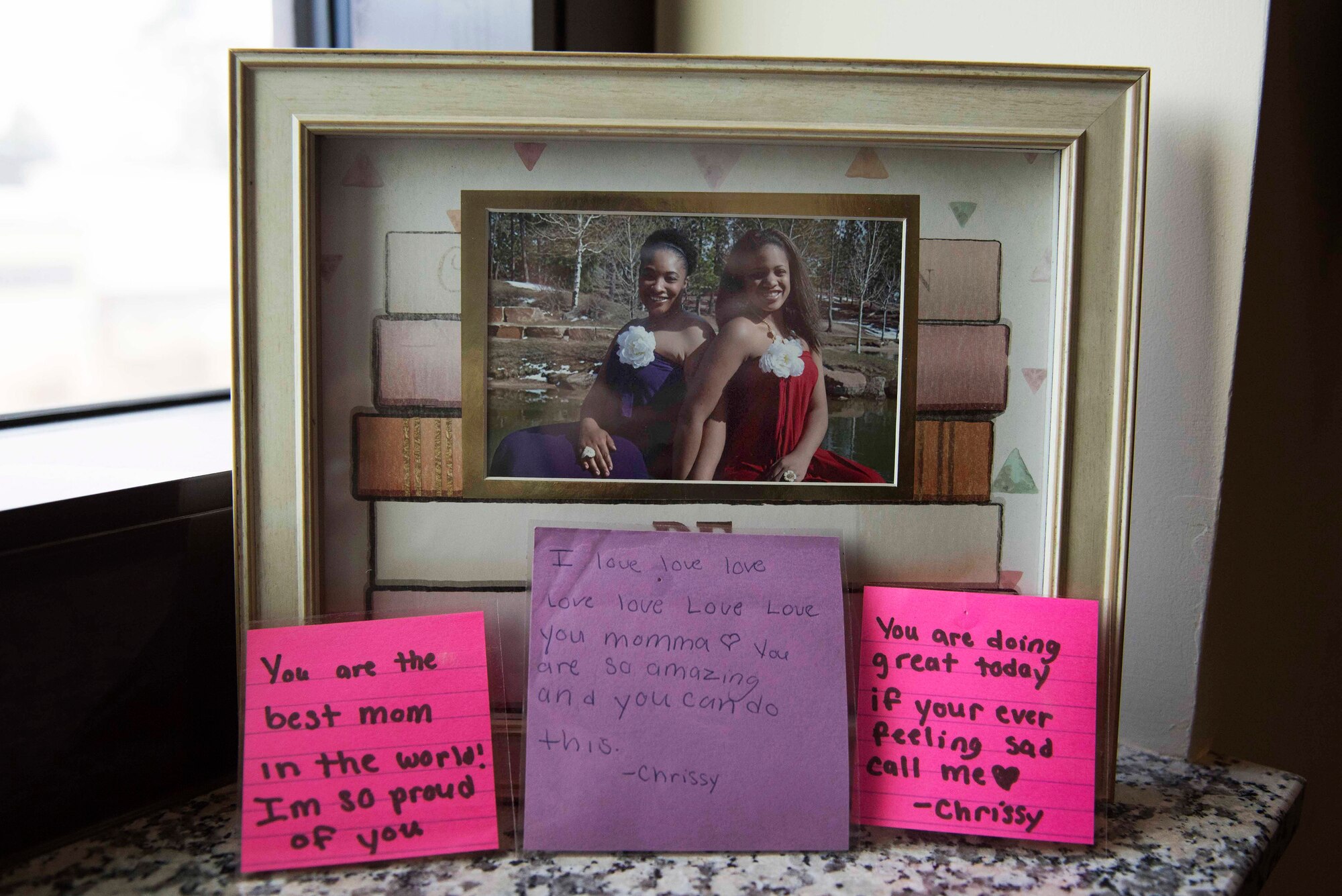 A framed picture shows U.S. Air Force Master Sgt. Debbie Jackson, 39th Air Base Wing career assistance advisor, (left), posing with her daughter, Chrissy, Feb. 21, 2020, at Incirlik Air Base, Turkey. Jackson gave up her daughter for adoption, but was still able to participate in raising her through the approval of Chrissy’s adoptive parents. (U.S. Air Force photo by Staff Sgt. Joshua Magbanua)