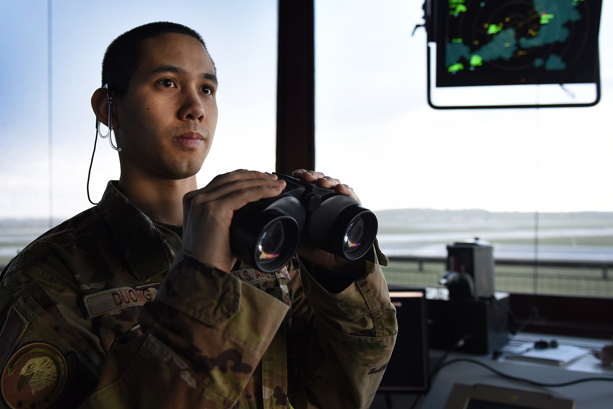 Airman 1st Class Howie Duong, 48th Operational Support Squadron air traffic controller, watches for aircraft preparing to depart at Royal Air Force Lakenheath, England, Feb. 25, 2020. Air traffic controllers are responsible for managing the flow of aircraft through all aspects of their flight and ensuring the safety and efficiency of air traffic on the ground and in the air. (U.S. Air Force photo by Airman 1st Class Jessi Monte)