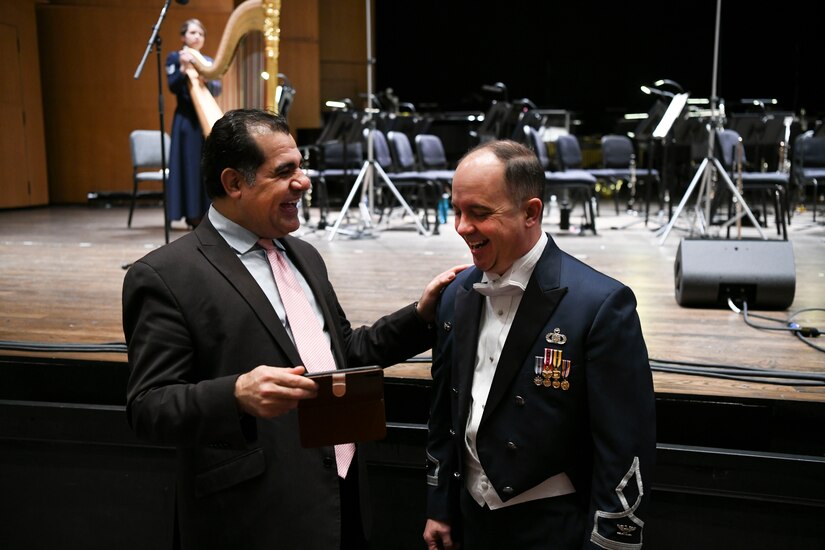 Col. Don Schofield, The United States Air Force Band commander and conductor, shares a laugh with a concert attendee before the Guest Concert Series at the Rachel M. Schlesinger Concert Hall and Arts Center in Alexandria, Va., Feb. 20, 2020. The concert featured the United States Air Force Concert Band, members of the Singing Sergeants and their guest performer, Samantha Massell. (U.S. Air Force photo by Airman 1st Class Spencer Slocum)