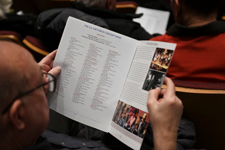 A concert guest views a program during the U.S. Air Force Band Guest Concert Series at the Rachel M. Schlesinger Concert Hall and Arts Center in Alexandria, Va., Feb. 20, 2020. The program outlines each performance and a list of all band members with what instrument they play. (U.S. Air Force photo by Airman 1st Class Spencer Slocum)