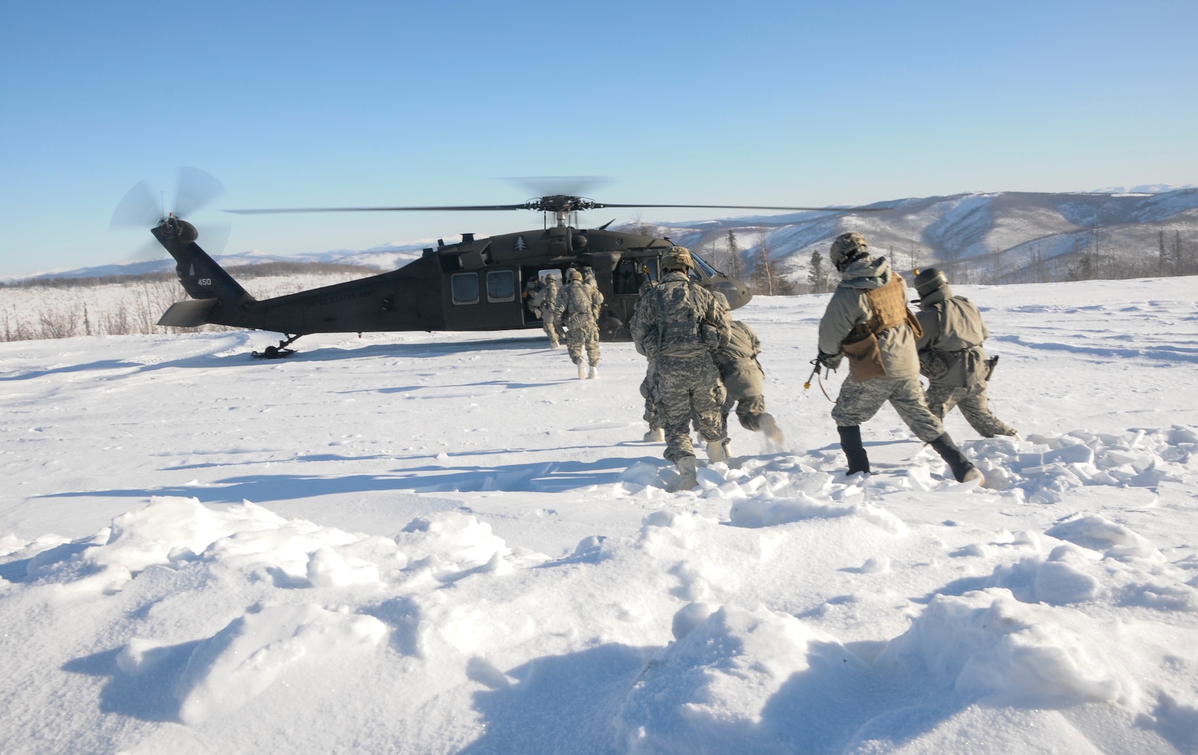 Members of 1st Battalion, 297th Infantry Regiment, Alaska National Guard, based in Fairbanks, Alaska, board a UH-60 Black Hawk helicopter operated by members of 1st Battalion, 169th Aviation Regiment of the New Hampshire National Guard Feb. 28, 2020, in the Yukon Training Area on Eielson Air Force Base as part of exercise Arctic Eagle 2020.