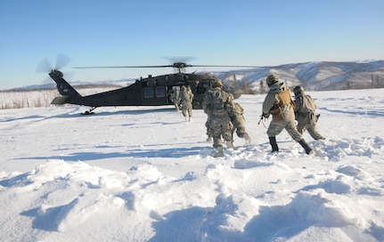 Members of 1st Battalion, 297th Infantry Regiment, Alaska National Guard, based in Fairbanks, Alaska, board a UH-60 Black Hawk helicopter operated by members of 1st Battalion, 169th Aviation Regiment of the New Hampshire National Guard Feb. 28, 2020, in the Yukon Training Area on Eielson Air Force Base as part of exercise Arctic Eagle 2020.