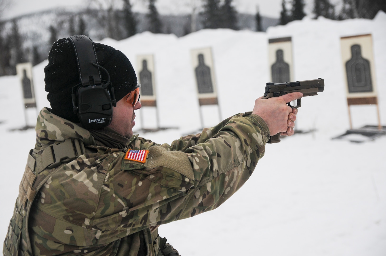 Staff Sgt. Sean E. Davis, a member of 1st Battalion, 297th Infantry Regiment, based in Joint Base Elmendorf-Richardson, Alaska, tests the new SIG Sauer M17 Army service pistol March 1, 2020, in the Yukon Training Area on Eielson Air Force Base as part of exercise Arctic Eagle 2020.