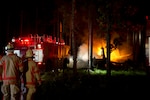 Emergency responders extinguish fires caused by a CV-22 Osprey aircraft crash on Eglin Range at Hurlburt Field, Fla., June 13, 2012.