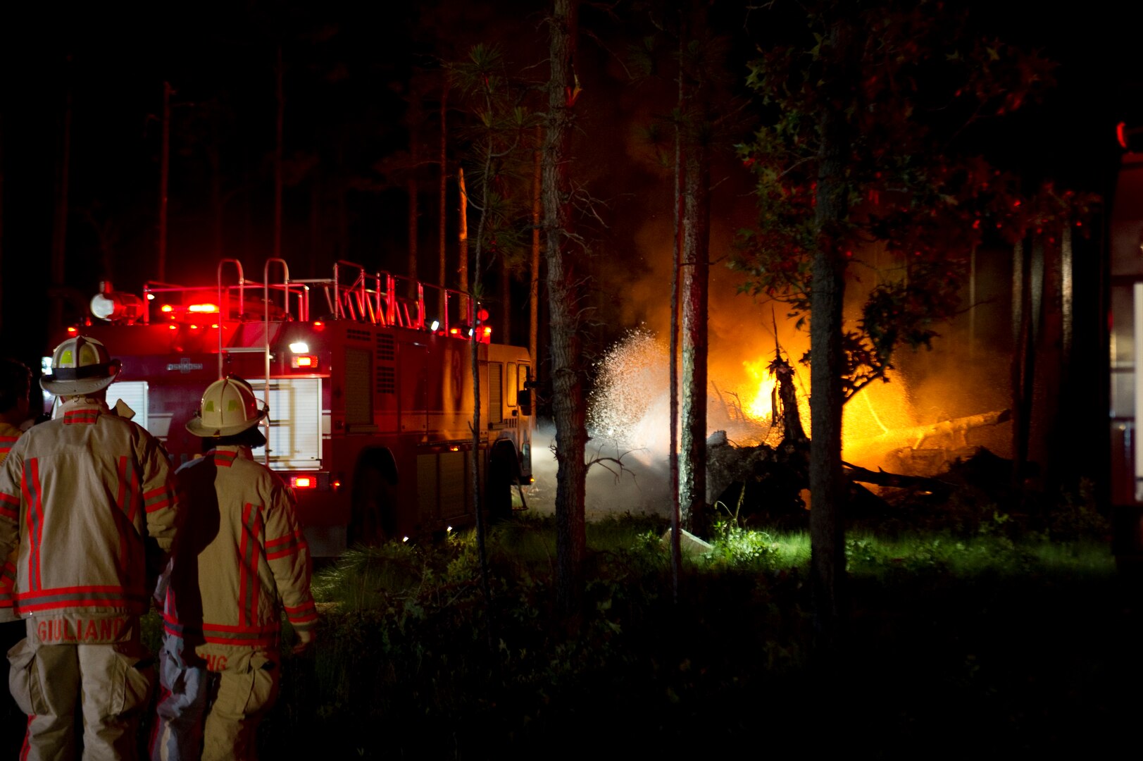 Emergency responders extinguish fires caused by a CV-22 Osprey aircraft crash on Eglin Range at Hurlburt Field, Fla., June 13, 2012.