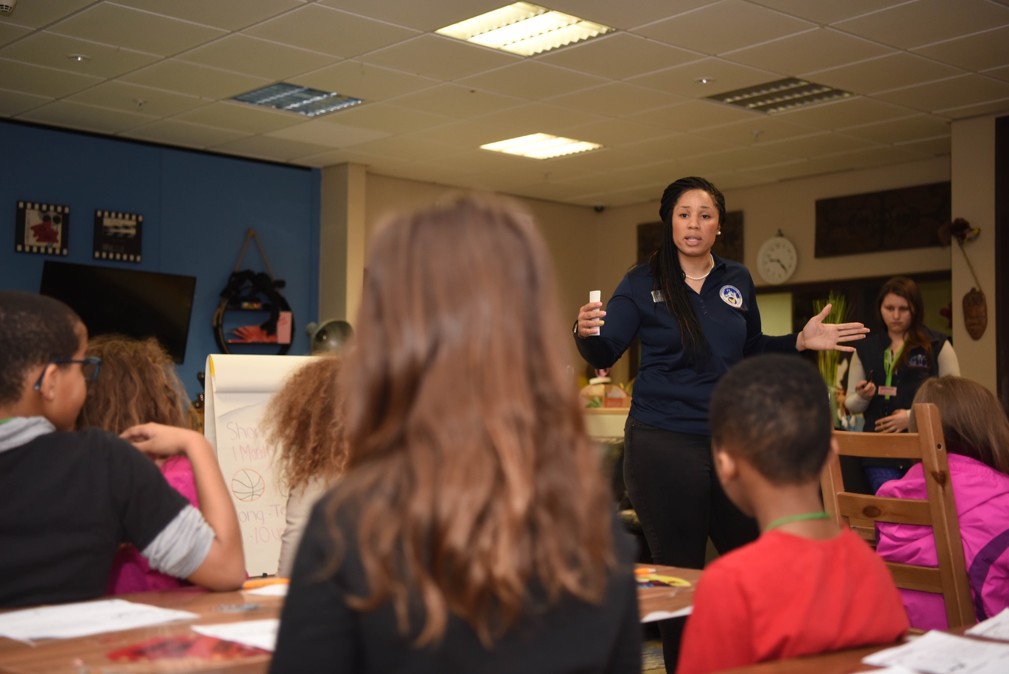 Angelica Williams, 86th Force Support Squadron Airman and Family Readiness Center community readiness consultant, responds to a question asked by one of the children who attended a “Youth Saves Event,” at the School Age Program building at Ramstein Air Base, Germany, Feb. 25, 2020. Throughout the presentation, children were taught basic money management principles such as saving, donating, investing and spending. The “Youth Saves Event” educates the younger generation on how to build their financial foundation. (U.S. Air Force photo by Senior Airman Kristof J. Rixmann)