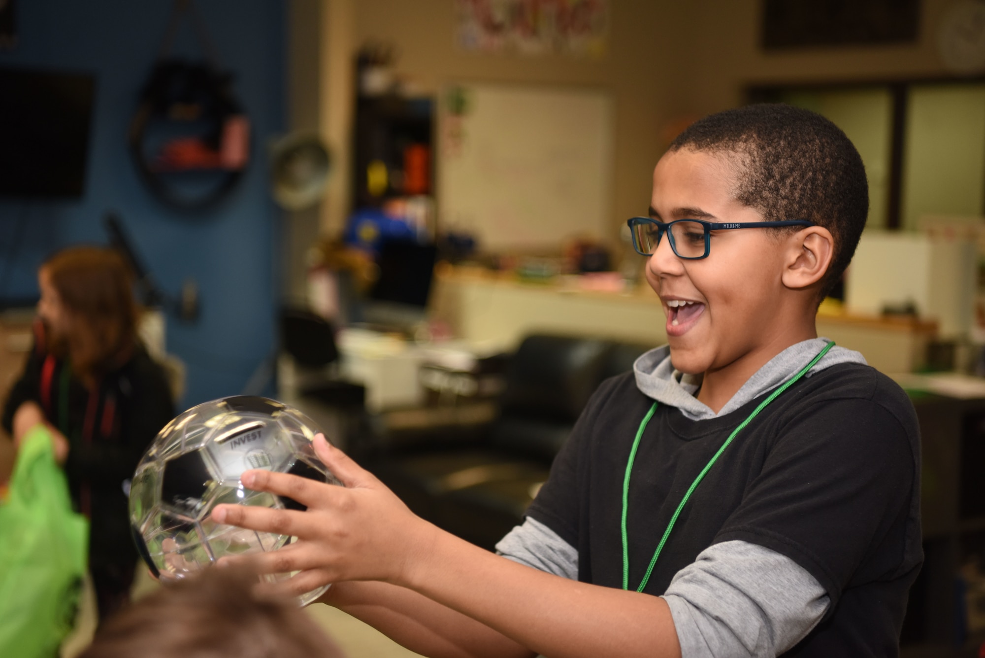 Knox Jasmin, son of U.S. Army Staff Sgt. Gaetan Jasmin, 21st Theater Sustainment Command transportation manager, receives a piggy-bank during the “Youth Saves Event” at the School Age Program building at Ramstein Air Base, Germany, Feb. 25, 2019. The event taught children how to build a financial foundation through saving, donating, investing and practicing good spending habits. To reinforce these four categories, the piggy-bank held in Jasmin’s hand is split into four evenly-divided categories.  (U.S. Air Force photo by Senior Airman Kristof J. Rixmann)