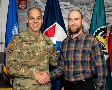 Gen. Gus Perna presents his commander's coin to Todd Davis.