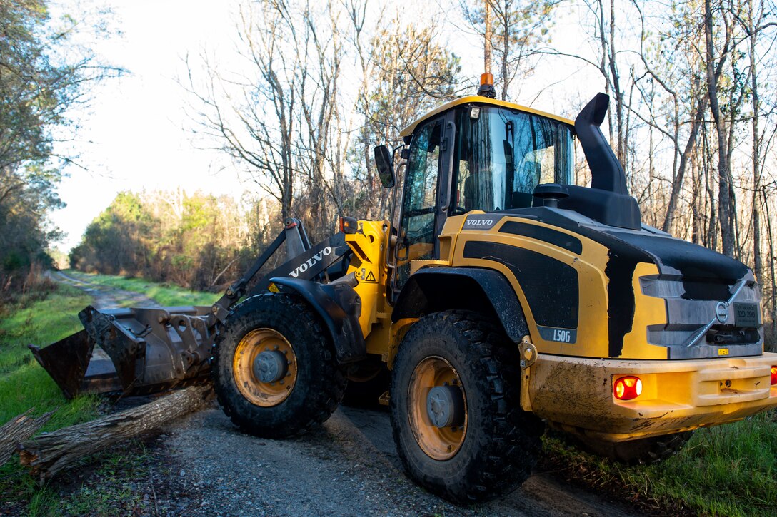 Photo of an Airman assigned to the 23d Civil Engineer Squadron clearing road debris during a natural disaster response exercise.