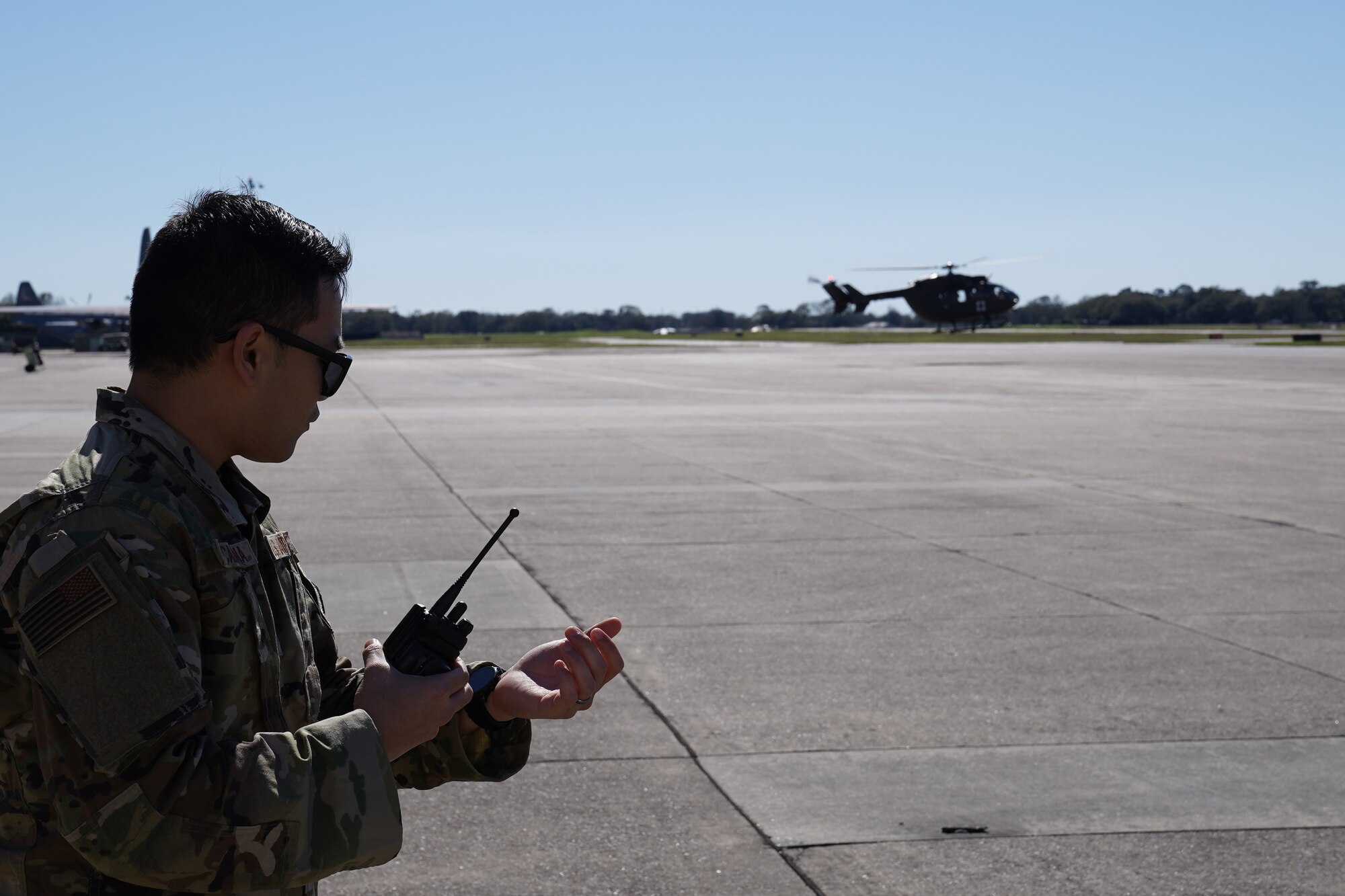 U.S. Air Force Staff Sgt. Catalino Escalona, 81st Aerospace Medicine Squadron flight and operational medical technician, watches a UH-72 Lakota helicopter take off during an exercise at Keesler Air Force Base, Mississippi, Feb. 27, 2020. The 81st Medical Group and the Mississippi Army National Guard worked together for an exercise, PATRIOT South, which involved transporting patients, in response to a simulated hurricane, from the Keesler Medical Center to the flightline where they would be airlifted to the Combat Readiness Training Center in Gulfport, Mississippi. "Exercises like this gives Keesler the opportunity to shape planning, assess and validate capabilities and address areas for improvement, making dragon medics more resilient during crisis situations," said Matthew Jalufka, 81st MDG medical emergency manager. (U.S. Air Force Airman 1st Class Kimberly L. Mueller)
