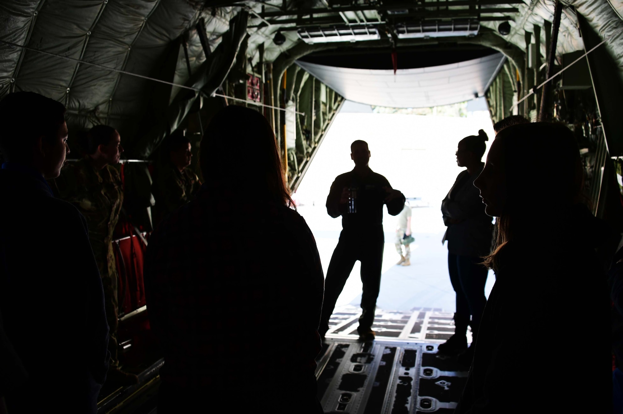 Photo of Col. Keith Ward speaking to students on the back of a C130-J.