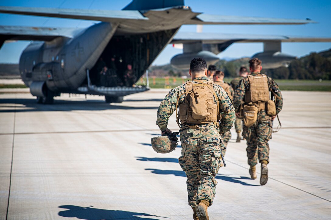 U.S. Marines run toward a KC-130J Hercules at Marine Corps Air Station Camp Pendleton, California, Feb. 4, 2020. The air station operates and maintains a secure airfield in order to support I Marine Expeditionary Force, Marine Corps Base Camp Pendleton tenant commands and visiting units to maintain and enhance their mission capabilities and combat readiness.(U.S. Marine Corps photo by Cpl. Dylan Chagnon)