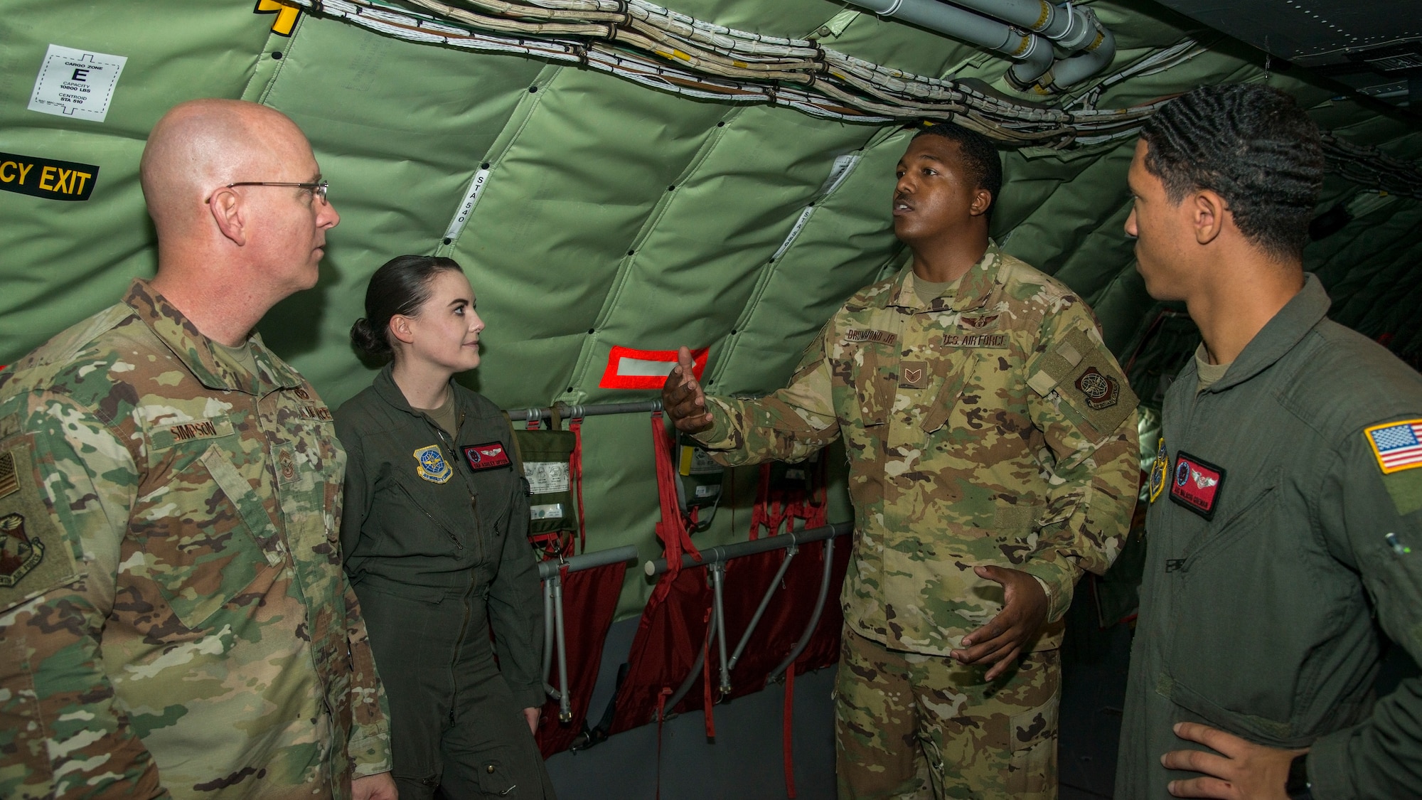 U.S. Air Force Staff Sgt. Cory Drummond Jr., a 50th Air Refueling Squadron (ARS) boom operator instructor, explains boom operator aircrew procedures to Chief Master Sgt. Daniel Simpson, the 18th Air Force command chief, aboard a KC-135 Stratotanker, Jan. 30, 2020.