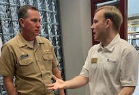 IMAGE: SPOTSYLVANIA, Va. (Feb. 29, 2020) – Capt. Casey Plew, Naval Surface Warfare Center Dahlgren Division (NSWCDD) commanding officer, speaks with Kyle Allwine, director of government affairs for the Fredericksburg Regional Chamber of Commerce, at the annual science, technology, engineering, mathematics (STEM) Summit open to the public at Chancellor High School. “Participating in STEM education is a valuable investment in both your future as well as society’s future,” Plew told students in his keynote speech. “Soak up the awesomeness of all of the different STEM efforts displayed for you. And get excited. One day, someone could be telling a future group of students about something amazing you developed – and it all started with you getting engaged in STEM at school.”