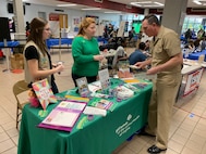 IMAGE: SPOTSYLVANIA, Va. (Feb. 29, 2020) – Capt. Casey Plew, Naval Surface Warfare Center Dahlgren Division (NSWCDD) commanding officer, talks with members of the Girl Scouts of the Commonwealth of Virginia at the annual science, technology, engineering, mathematics (STEM) Summit hosted by Chancellor High School. Plew was among the NSWCDD leaders, scientists and engineers who joined a myriad of organizations to engage students with science, technology, engineering, mathematics (STEM) demonstrations. “With new programs in outdoor adventure and STEM and the promise of dozens of new skills to learn and awards to earn, at Girl Scouts the trail is yours to blaze,” according to the organization’s website. (U.S Navy photo/Released)