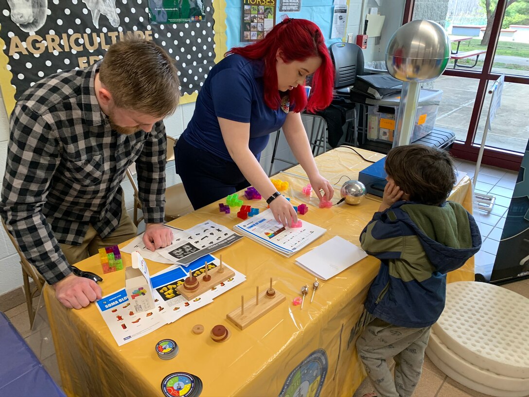 IMAGE: SPOTSYLVANIA, Va. (Feb. 29, 2020) – Science, technology, engineering, mathematics (STEM) mentors from Naval Surface Warfare Center Dahlgren Division (NSWCDD)  use Soma blocks to pique an elementary school student’s interest in STEM at the annual science, technology, engineering, mathematics (STEM) Summit hosted by Chancellor High School. They were among the NSWCDD leaders, scientists and engineers who joined a myriad of organizations to engage students with STEM technologies and demonstrations. (U.S. Navy photo/Released)