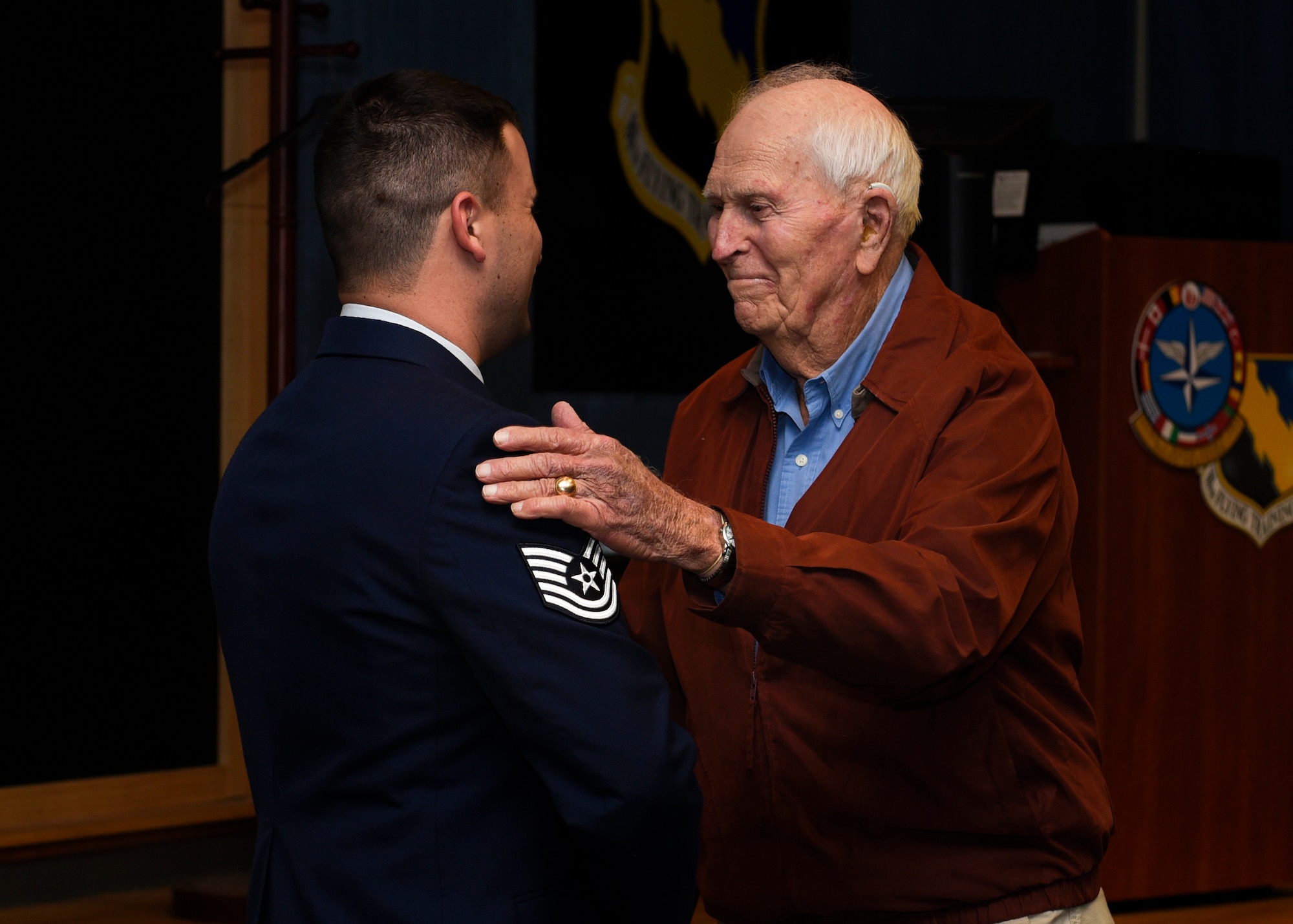 Tech. Sgt. Joe Jones and his grandfather U.S. Army Capt. (Ret) Joe Jones, shake hands at Sheppard Air Force Base, Texas, Feb. 28, 2020. Jones invited his grandfather to see him promote in person for the first time. In a monologue, Jones stated he did not think he would make it this far in his career, considering his decisions before joining the Air Force. His grandfather jokingly said he also did not think Jones would make it, but then said he is proud of his grandson for being in the Air Force. (U.S. Air Force photo by Senior Airman Pedro Tenorio)