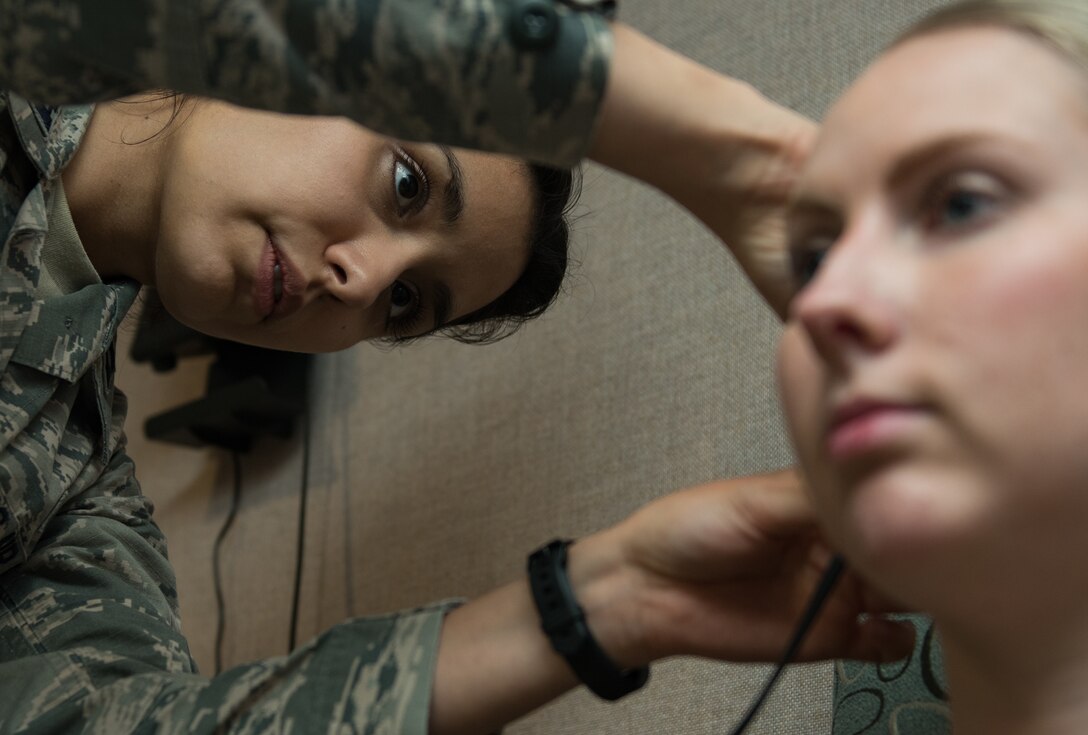 A medic from 633d Aerospace Medicine examines a patient at the Langley Audiology Clinic.