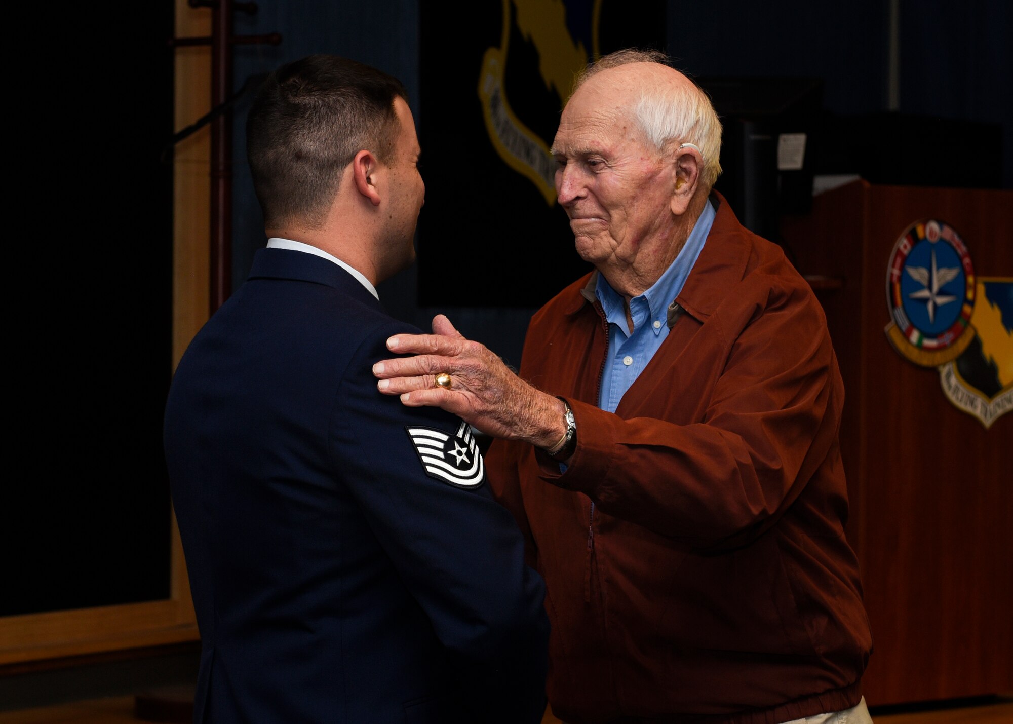 Tech. Sgt. Joe Jones and his grandfather U.S. Army Capt. (Ret) Joe Jones, shake hands at Sheppard Air Force Base, Texas, Feb. 28, 2020. Jones invited his grandfather to see him promote in person for the first time. In a monologue, Jones stated he did not think he would make it this far in his career, considering his decisions before joining the Air Force. His grandfather jokingly said he also did not think Jones would make it, but then said he is proud of his grandson for being in the Air Force. (U.S. Air Force photo by Senior Airman Pedro Tenorio)
