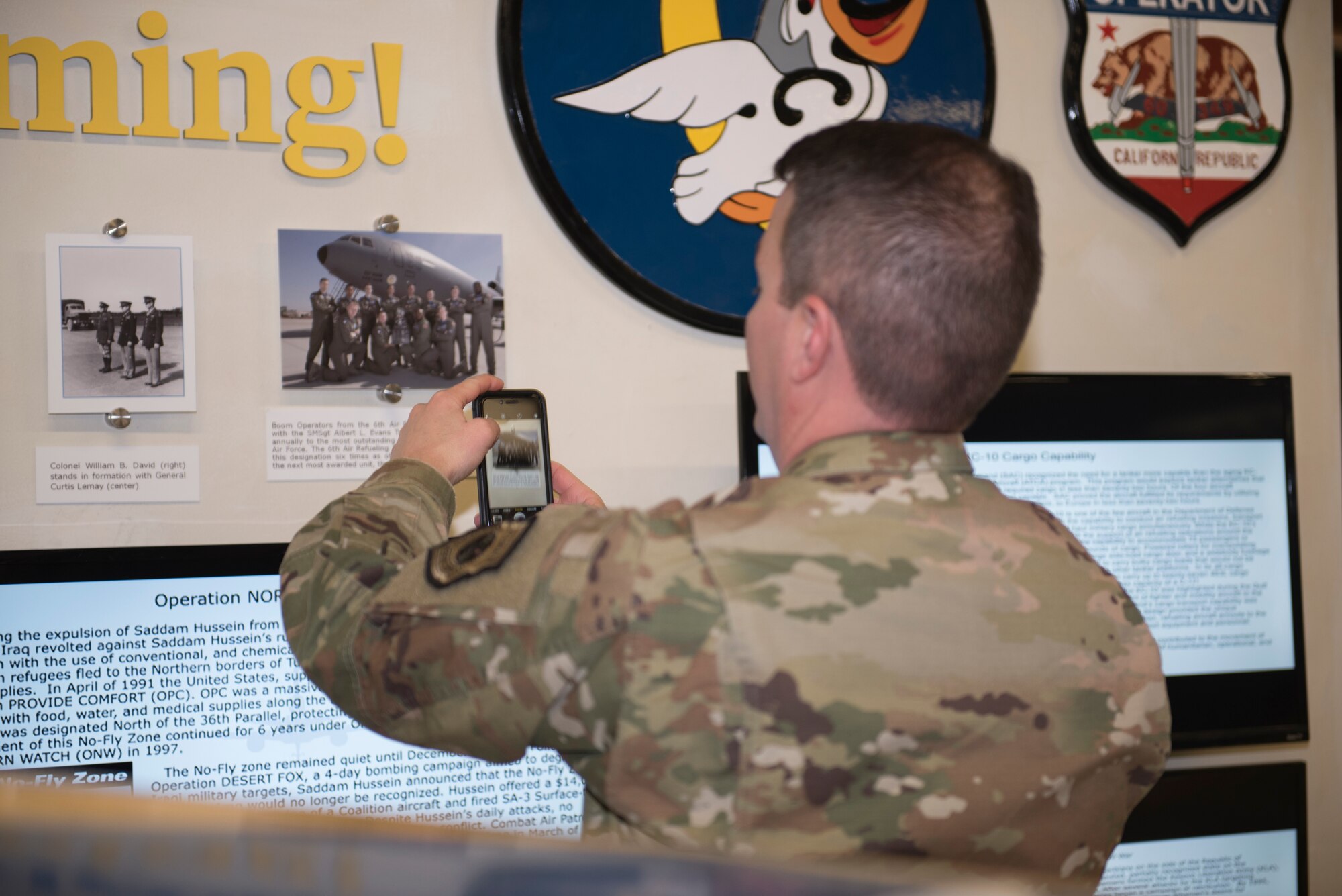 U.S. Air Force Col. Jeffrey Nelson, 60th Air Mobility Wing commander, takes a photo of the of 6th Air Refueling Squadron heritage display during Leadership Rounds Feb. 28, 2020, at Travis Air Force Base, California. The Leadership Rounds program provides 60th AMW leadership an opportunity to interact with members of Team Travis and get a detailed view of each mission performed on base. (U.S. Air Force photo by Airman 1st Class Cameron Otte)