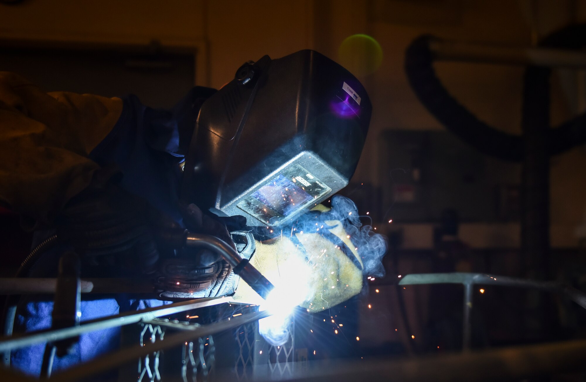 U.S. Air Force Senior Airman Tyler case, 92nd Maintenance Squadron aircraft medals technology journeyman, welds a section of stairs Feb. 27, 2020, at Fairchild Air Force Base, Washington.