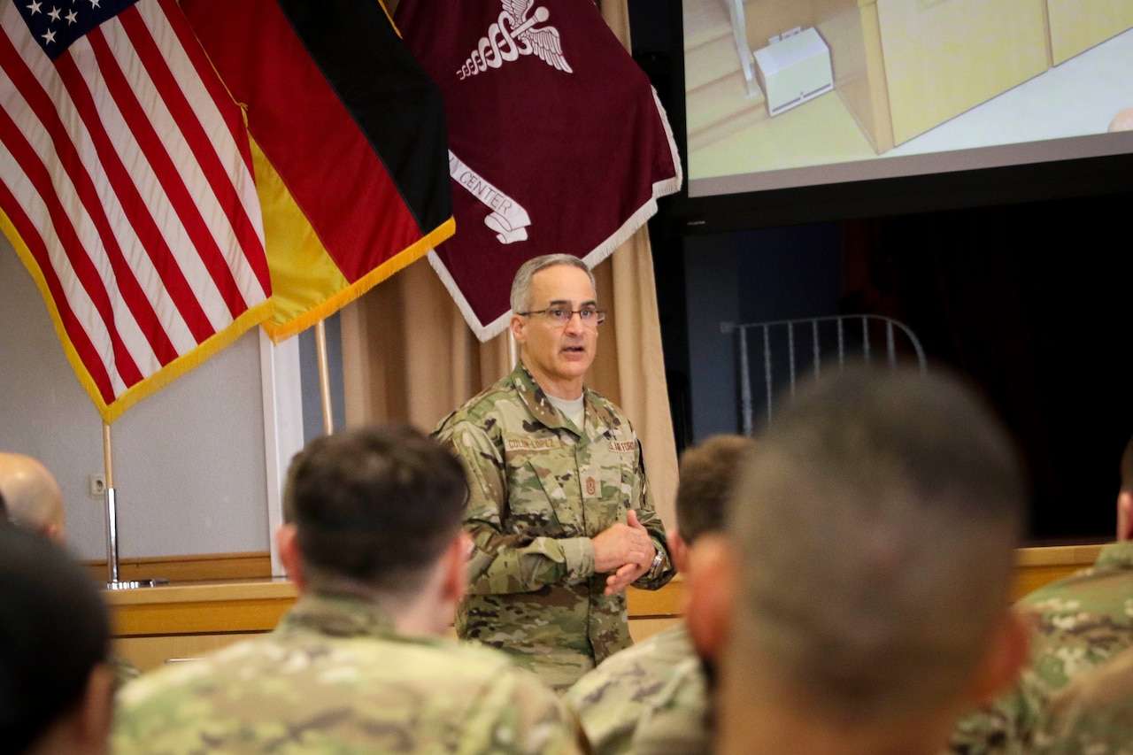 Man in uniform speaks to troops.