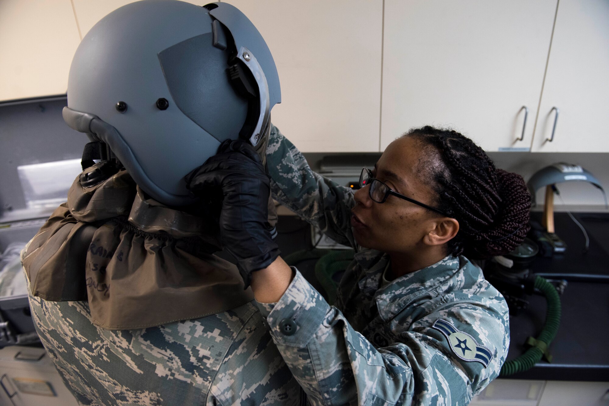 U.S. Air Force Airman 1st Class Stephanie Grant, 92nd Operations Support Squadron Aircrew Flight Equipment technician, fits a helmet during a respirator test at Fairchild Air Force Base, Washington, Feb. 27, 2020.
