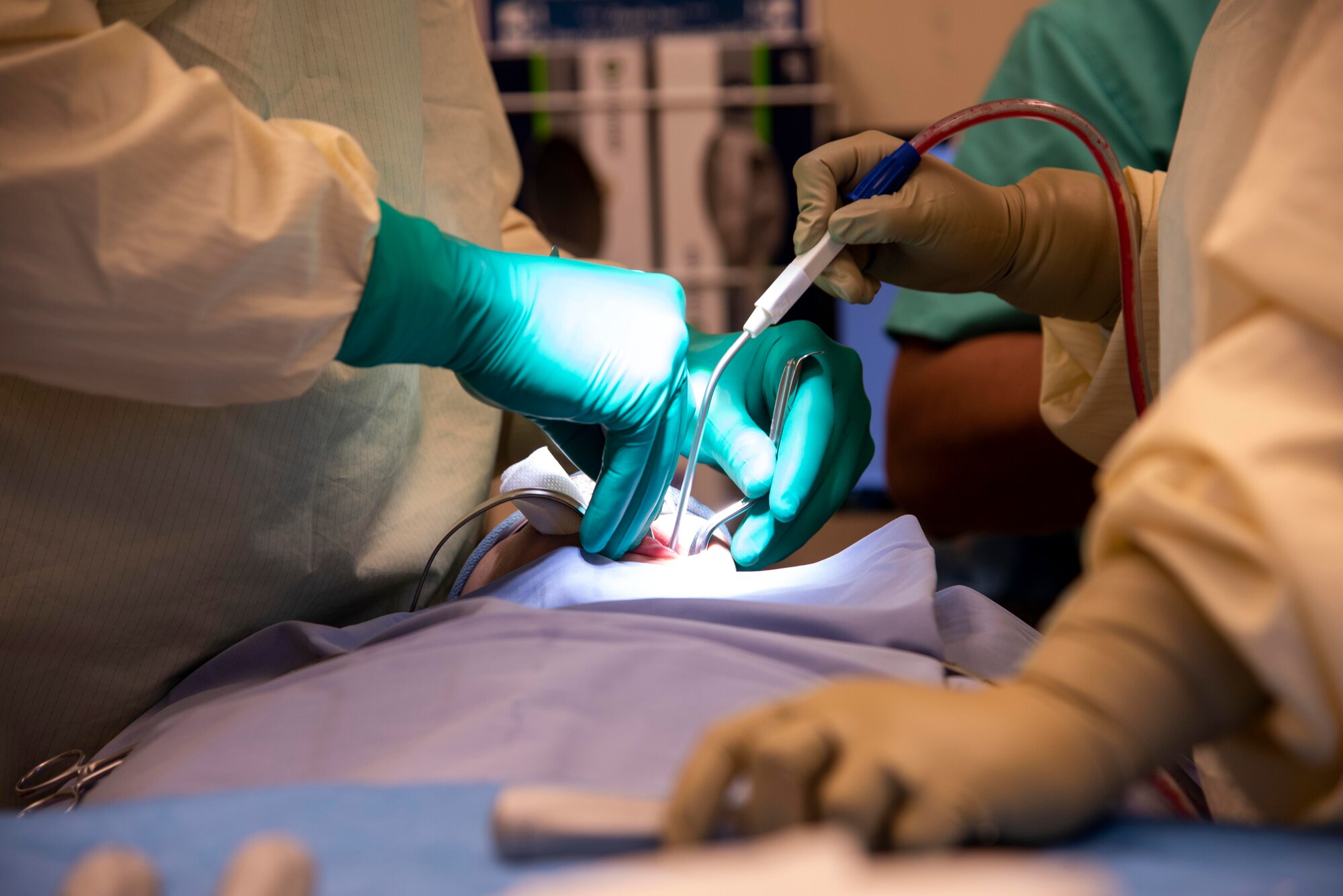 U.S. Air Force Capt. Mark Sunden, 92nd Aerospace Medical Squadron oral surgeon, and Mrs. Jessica Krueger, oral surgery assistant, perform oral surgery on a patient February 27, 2020, at Fairchild Air Force Base, Washington.