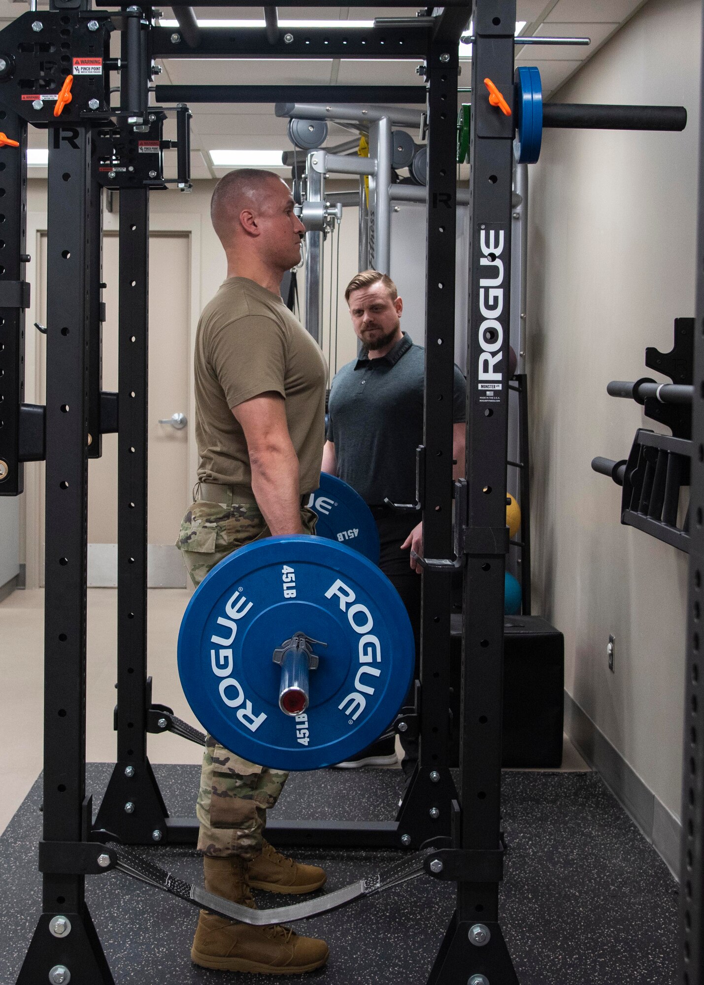 U.S. Air Force David Martin, physical therapy assistant assists a patient with lift exercises, Feb. 27, 2020, at Fairchild Air Force Base, Washington.
