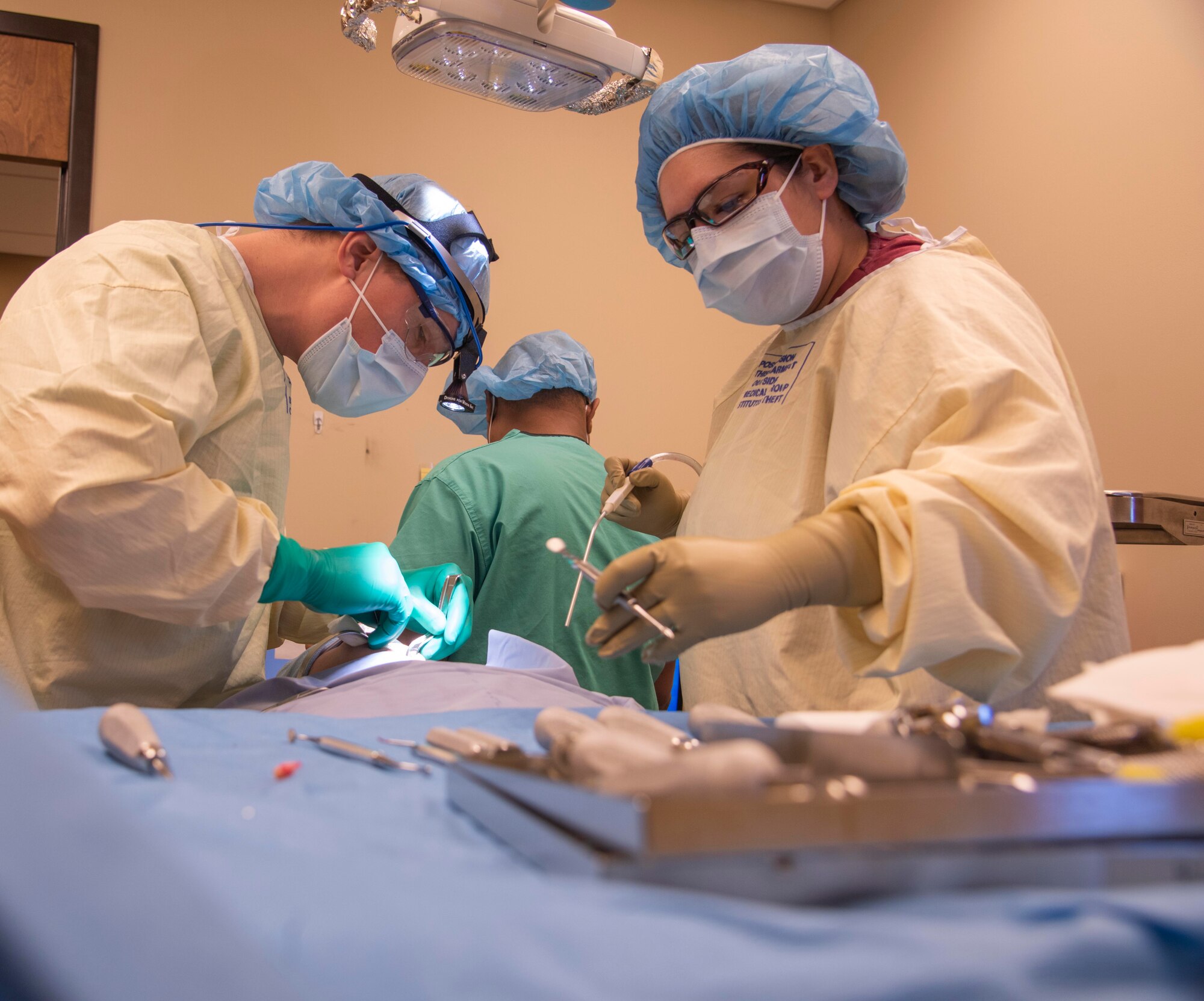 U.S. Air Force Capt. Mark Sunden, 92nd Aerospace Medical Squadron oral surgeon, and Mrs. Jessica Krueger, oral surgery assistant, perform oral surgery on a patient Feb. 27, 2020, at Fairchild Air Force Base, Washington.