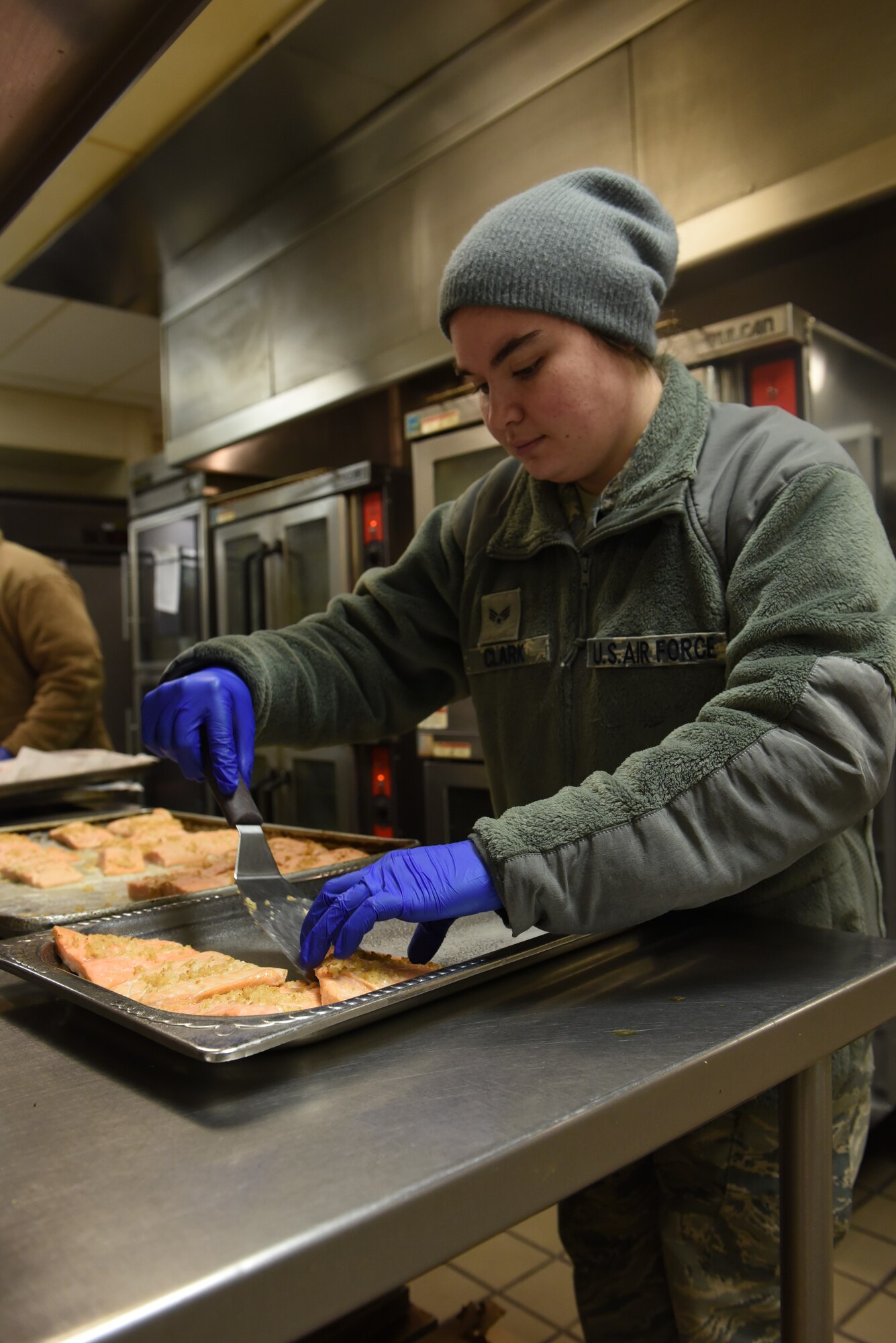 U.S. Air Force Senior Airman Alfredo Legaspi, 92nd Force Support Squadron services shift lead, prepares food for midnight dinner, Feb. 27, 2020, at Fairchild Air Force Base, Washington.